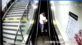 Couple tumble down escalator after kissing each other in northern China