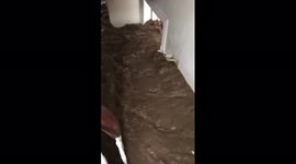Muddy water rages inside building in Liege, Belgium as scores die in flooding