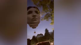 Bizarre giant head hot air balloon floats over Tokyo, Japan
