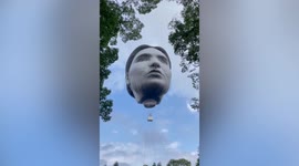 Bizarre giant-head hot air balloon floats over Tokyo, Japan