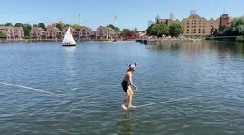 Slackliners practice above water in East London as UK enjoys heatwave