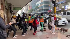 South African clean-up crews dance as they clear mess from looting in Durban