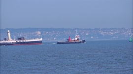 Historic paddle steamer Medway Queen seen under tow in Kent, UK