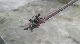 Workers rescued by crane from rapid floodwater in northern India