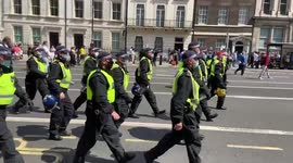 Riot police move to disperse protesters at the Freedom Day anti-vaccination passports demonstration in London, United Kingdom