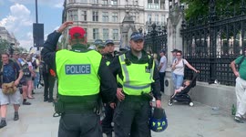 13. Police are booed by angry crowds outside the Houses of Parliament at London anti-lockdown rally