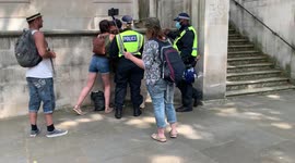 19. Arrestees are held by police in Whitehall during London anti-lockdown protest