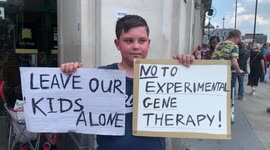 8. A child holds anti-vaccination for children placard in London anti-lockdown protest