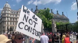 4. Woman holds 'We Do Not Consent' placard as other woman claims that no one is interested in terrorism anymore at London anti-lockdown protest