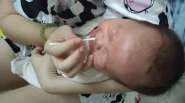 Newborn baby crying so badly when her nose is cleaned by her mom