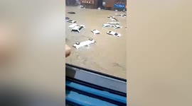 Vehicles submerged in floodwater after rainstorm hits central China
