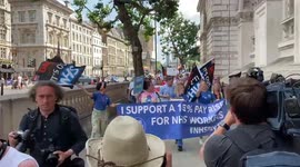 Protesters march in Whitehall in support of a 15% pay rise for NHS workers, London, UK