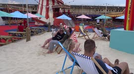 London Wonderground visitors enjoy white sand beach in Earls Court - Kensington+Chelsea Festival 2021