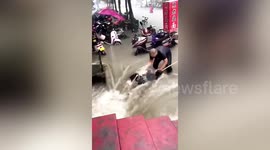 Watch moment woman is pulled out of raging China flood in dramatic rescue