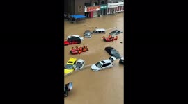 Street turned into lake with floating cars in Zhengzhou, China