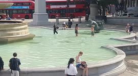 Londoners cool down in Trafalgar Square fountains as UK heatwave continues