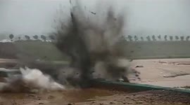 Chinese soldiers blast open dam to discharge floodwater