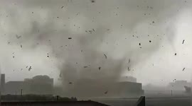 Debris swirls above Chinese city as tornado strikes, killing 2