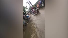 Flood causes slow traffic in narrow roads in Philippines as twin typhoons In-fa and Cempaka batters country