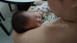 One month old baby fall asleep when sucking her dad's fake nipple