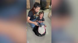 Toddler stops crying after mom breaks piggy bank with money inside