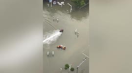 Man drives motorboat to rescue people trapped in floodwater in central China