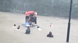 Residents smash car's windows to rescue kids trapped in submerged vehicle amid China's floods