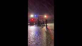 Firefighters rescue man in street during heavy rainfall monsoon in Tucson Arizona