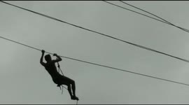 Terrifying moment linemen get stuck on 50-foot electric wire above swollen river