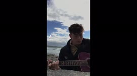 Boy singing and playing the guitar
