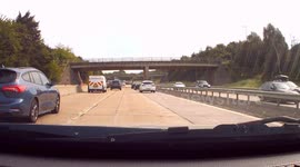 DASHCAM - Driver on Motorway weaves all over the road before dangerously undertaking.