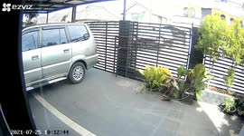 CCTV footage capture moment of car drifting after avoiding hitting a crossing stray dog in Indonesia