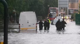 Motorists wade through thigh-high floods in east London