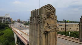 Establishing scenes of a Guardian of Transportation statue and downtown Cleveland, with the stadium in view