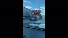 Motorist can't resist temptation to drive UNDER tractor on public road