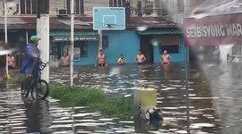 Locals hold Olympics-style swimming race on road flooded by typhoon In-fa in the Philippines