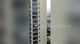Glass windows plummet from high-rise building as Typhoon In-fa strikes China