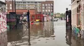 Kayaker paddles down flooded London street after torrential rain hits UK capital