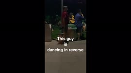 Guy dancing in reverse at summer concert