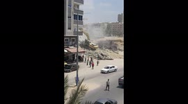 Excavator used to remove rubble remaining from Israeli attacks on Gaza