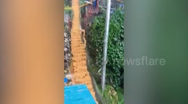 Muddy floodwater gushes during Typhoon In-fa in Philippines