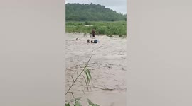 Drifting Filipino couple dramatically saved from typhoon floods
