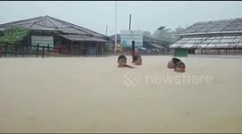 Bangladesh citizens left in neck-deep water after deadly landslide, flooding