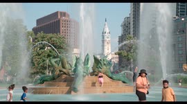 Parents and their children beat the 2021 heat in the water fountains at Logan Square