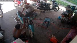 Motorcycle bursts into flames while being repaired in a garage in Thailand