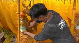 Buddhist dieties given Covid-19 face masks for annual candle sculpture festival