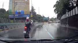 Motorcycle rider wiped out by huge wave from puddle during typhoon In-fa in the Philippines