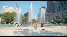 Parents and their children beat the 2021 heat in the water fountains at Logan Square