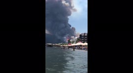People watch the wildfire from the sea in Marmaris, Muğla, Turkey