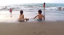 Babies Playing Sand and Swimming in The Sea